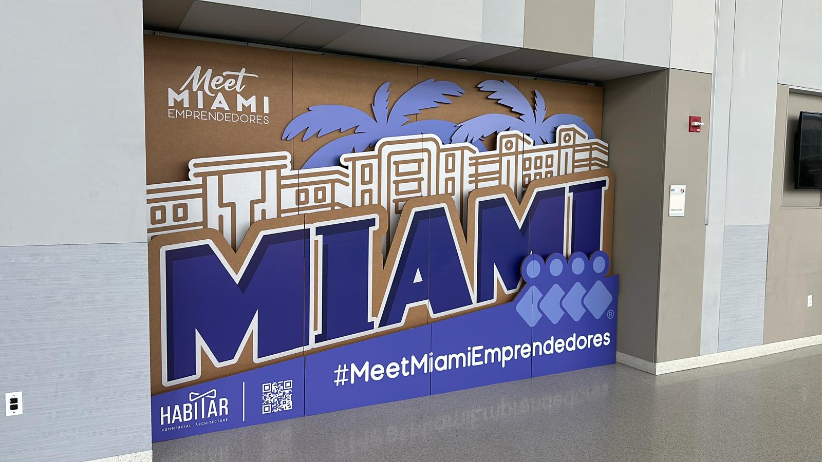 Custom cardboard backdrop display with Habitar 91 logo installed in a modern architecture and design office